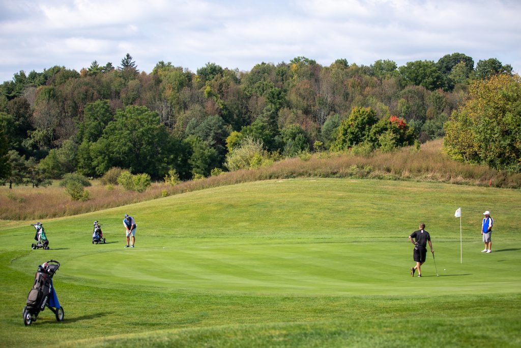 A golfer makes a long putt onto the green on one of the holes of Drumlins East Course, who partners with Syracuse University Barnes Center at The Arch.