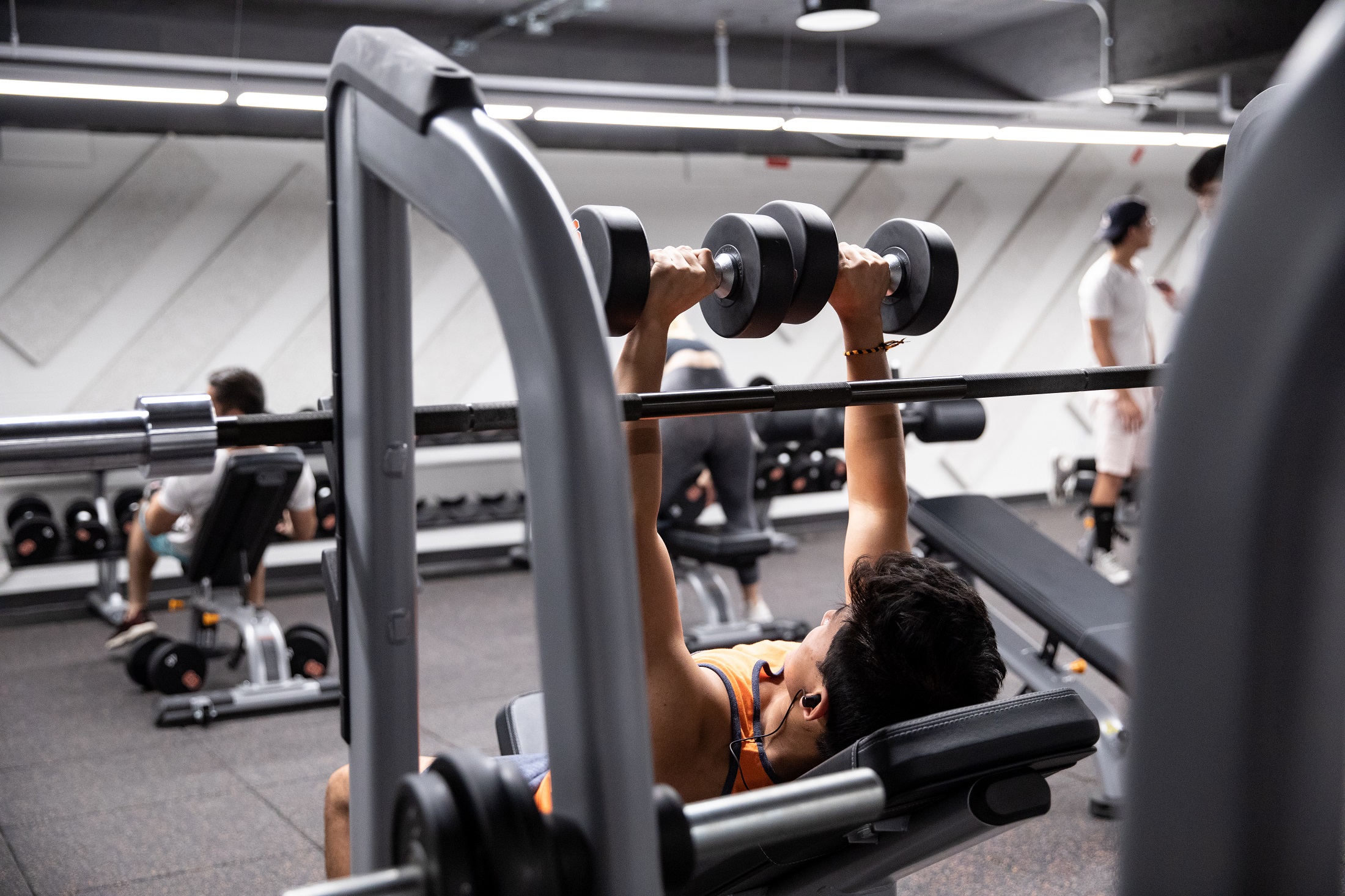 Student lifts weights in the Barnes Center.