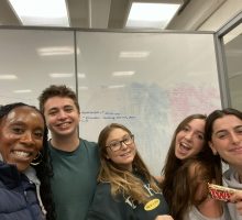 Students smiling with Syracuse University Dean of Students Dean Dixon.