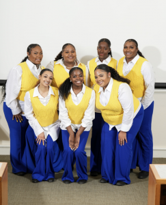 Picture of members of Sigma Gamma Rho Sorority, Inc., in front of a white wall