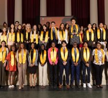 WellsLink students and guests stand for a photo at the WellsLink Transition Ceremony. Most in the photograph are wearing gold stoles.