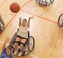 Students play basketball in wheelchairs in the Barnes Center at The Arch.