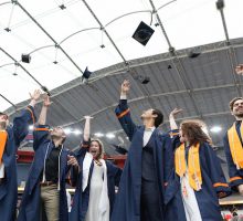 Students toss their caps at the end of the Commencement ceremony