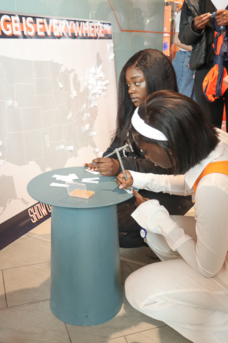 Students add to a board sharing their hometowns at Senior Celebration.