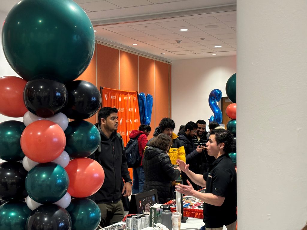 Image of the off-campus housing fair with students interacting with property managers