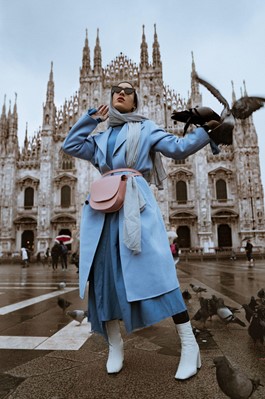 A person wearing lots of layers of blue clothing.