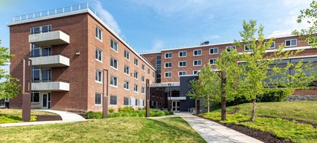 The exterior of Shall Hall on a sunny day.