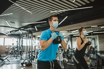 Two people workout with kettlebells