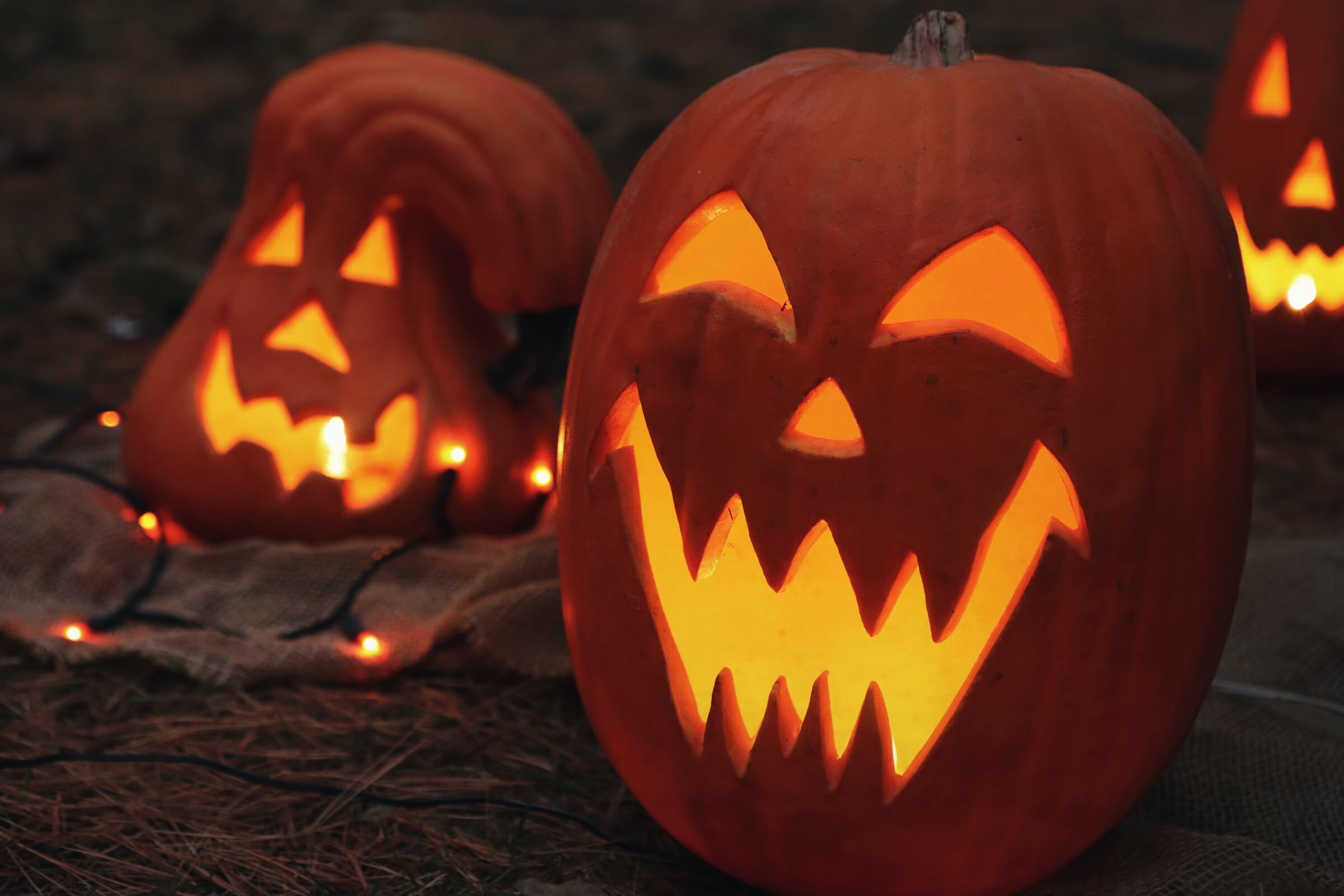 Two illuminated jack-o-lanterns