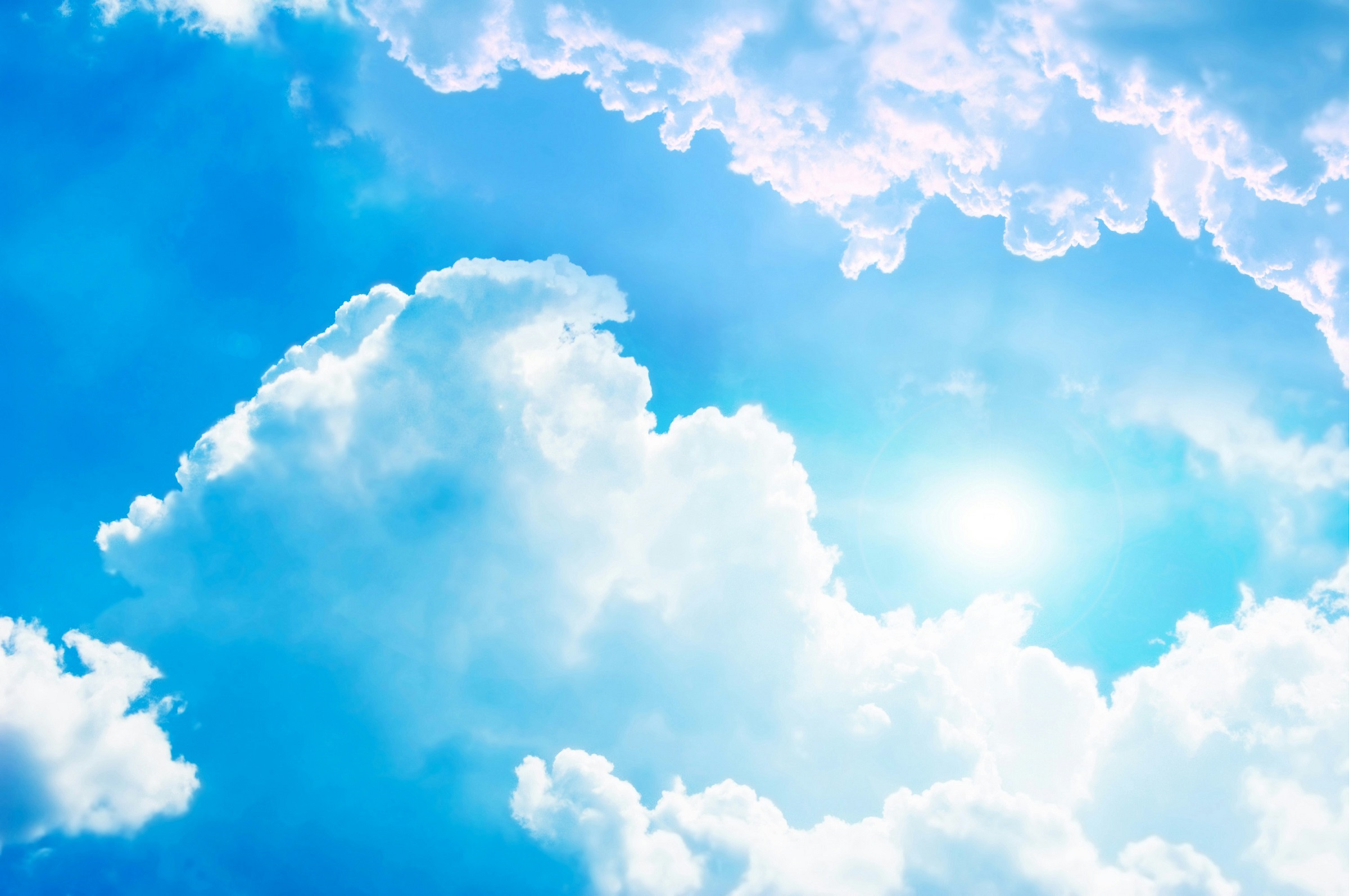 A blue sky with white fluffy clouds.
