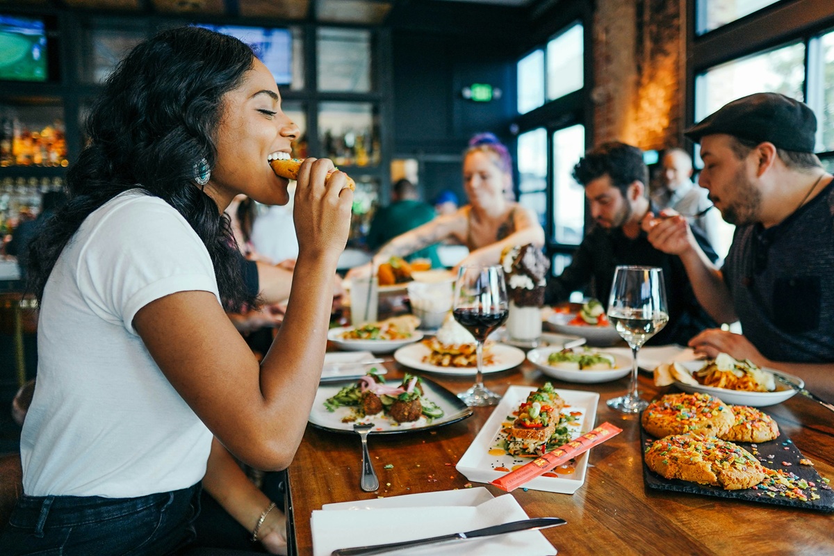 People eat together at a table in a restaurant.