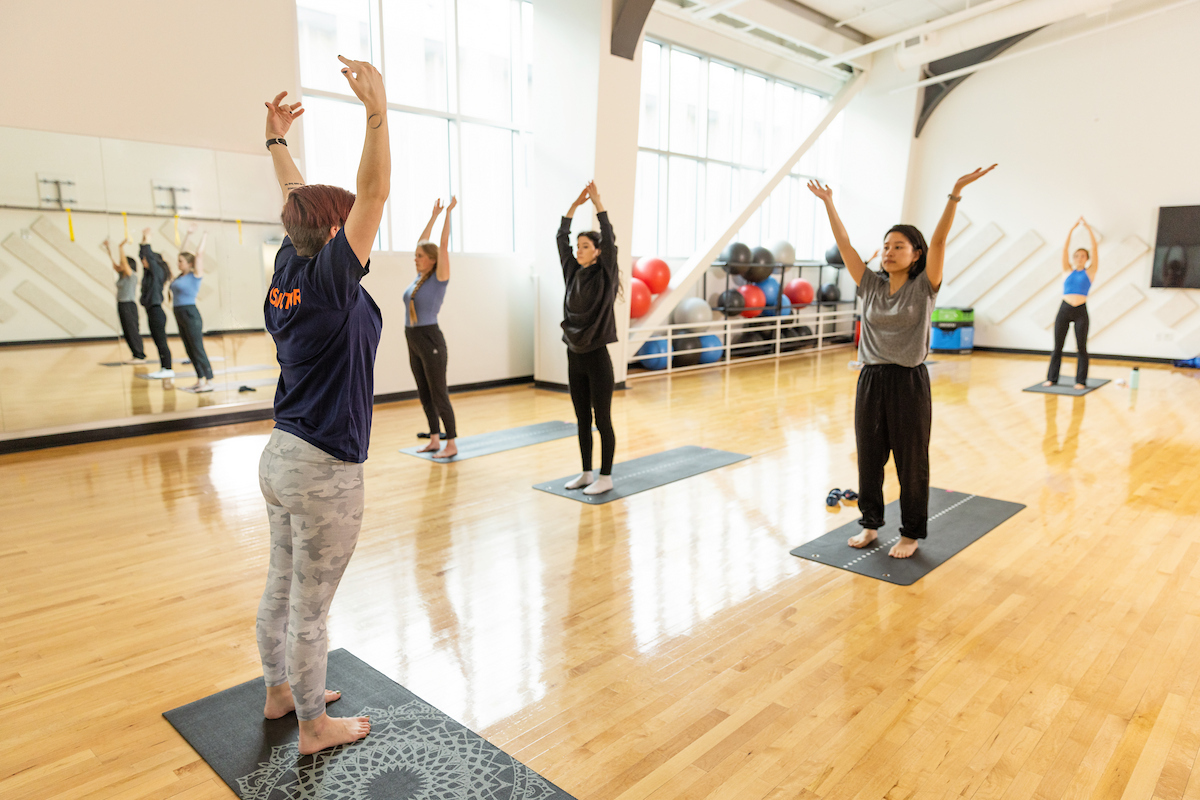 Students taking a yoga class at the Barnes Center.