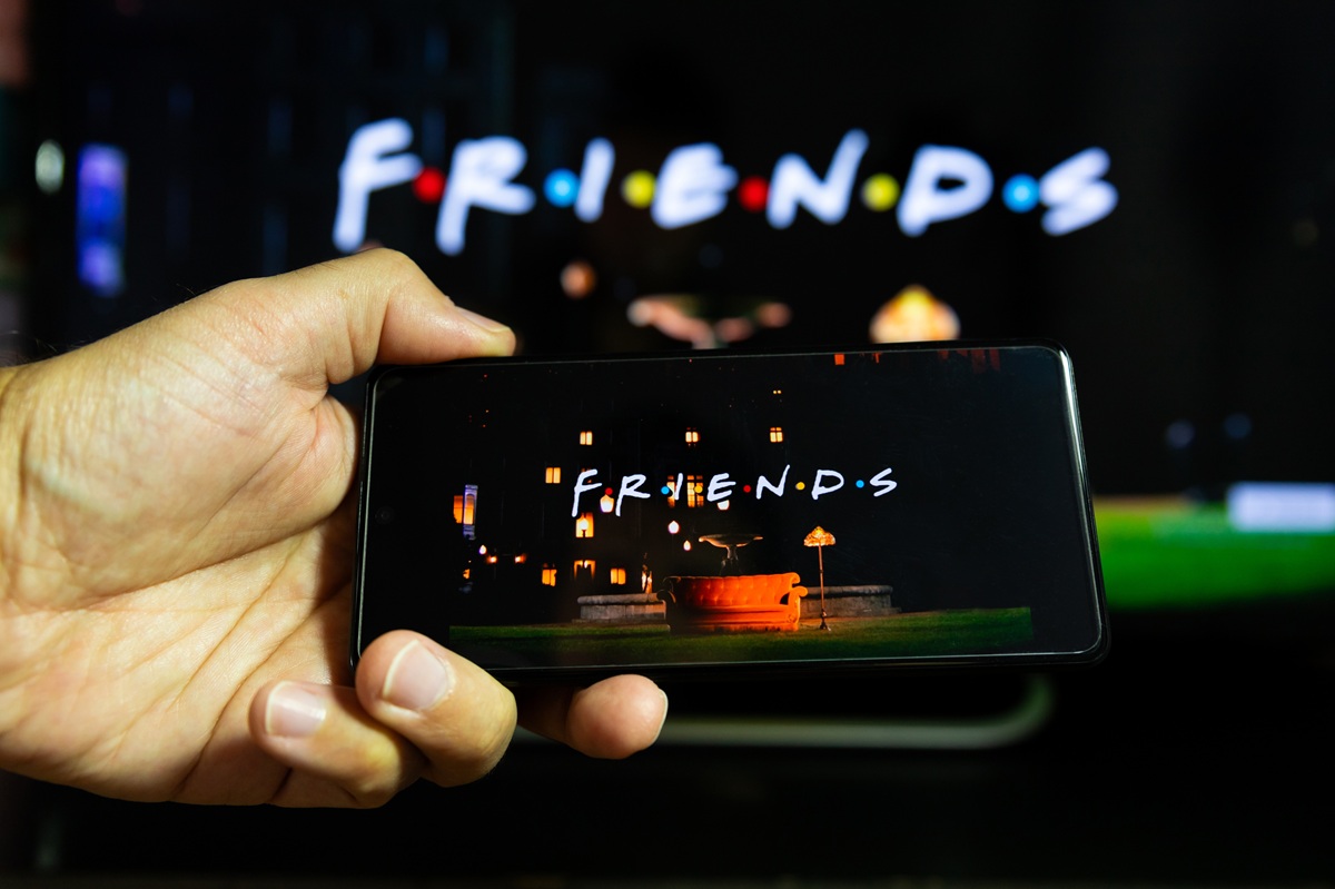 A person watches "Friends" on their smartphone.