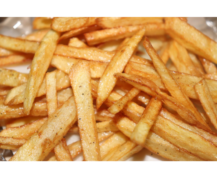 Close-up of a pile of golden, seasoned French fries.