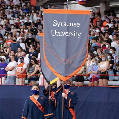 Senior Class Marshals hold Syracuse University banner at New Student Convocation