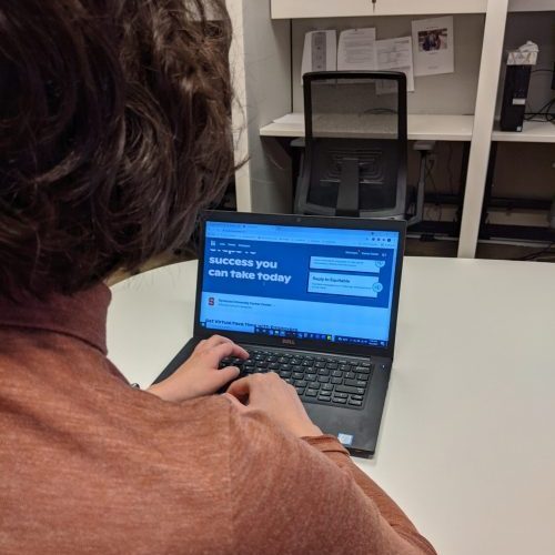 Back of person's head while using a lap in an office